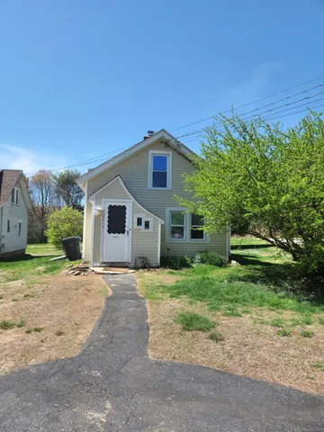 a yellow house with a yard