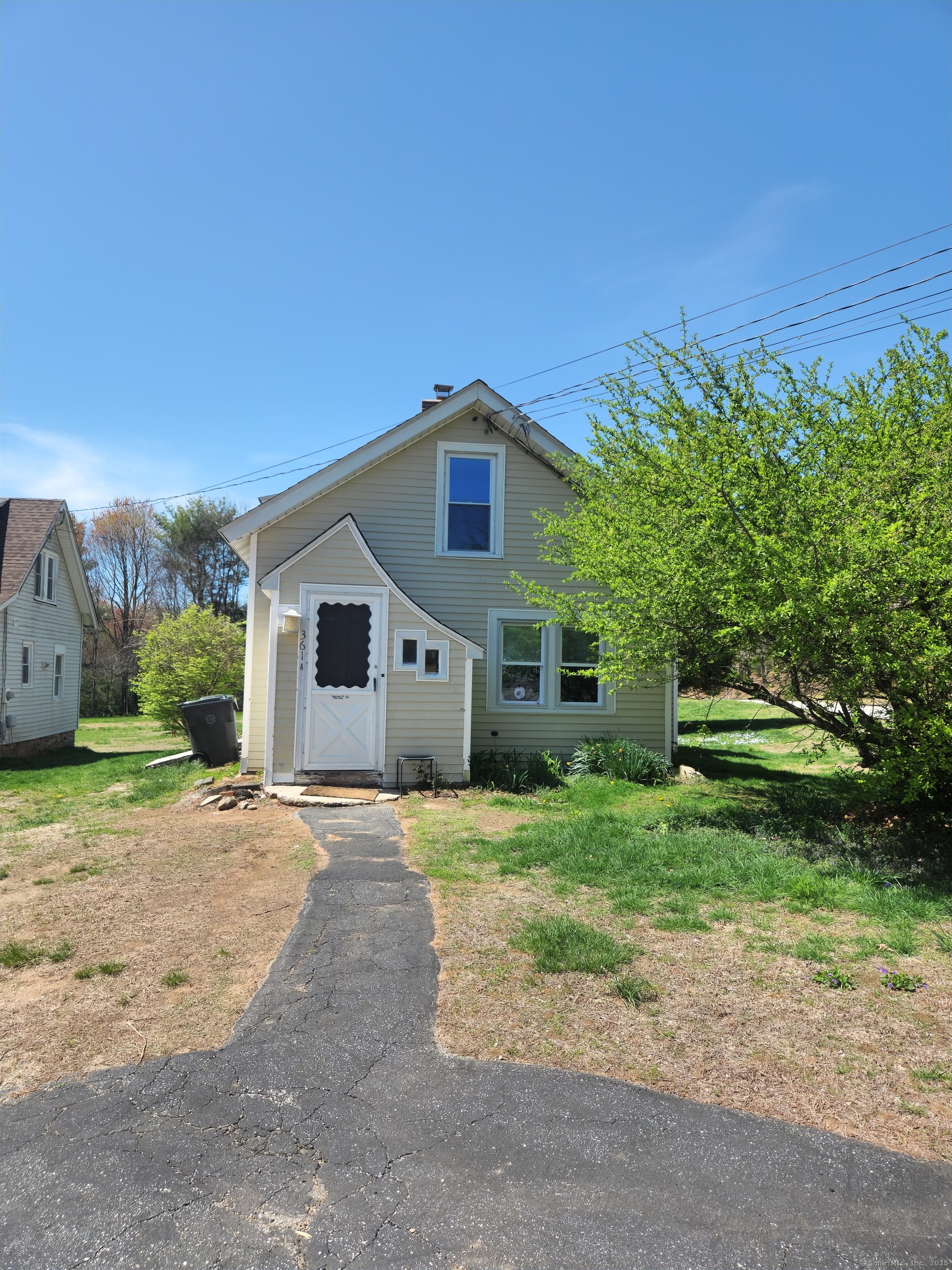 a yellow house with a yard