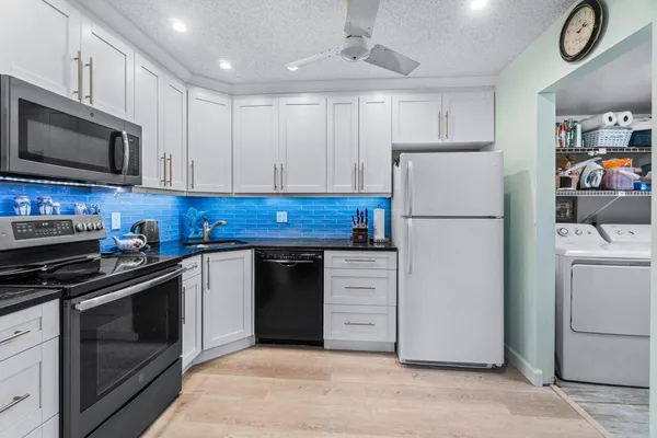 a kitchen with cabinets and steel stainless steel appliances