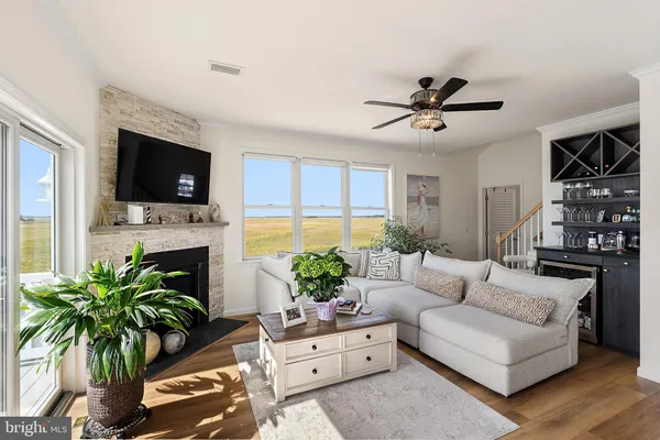 a living room with furniture kitchen view and a chandelier