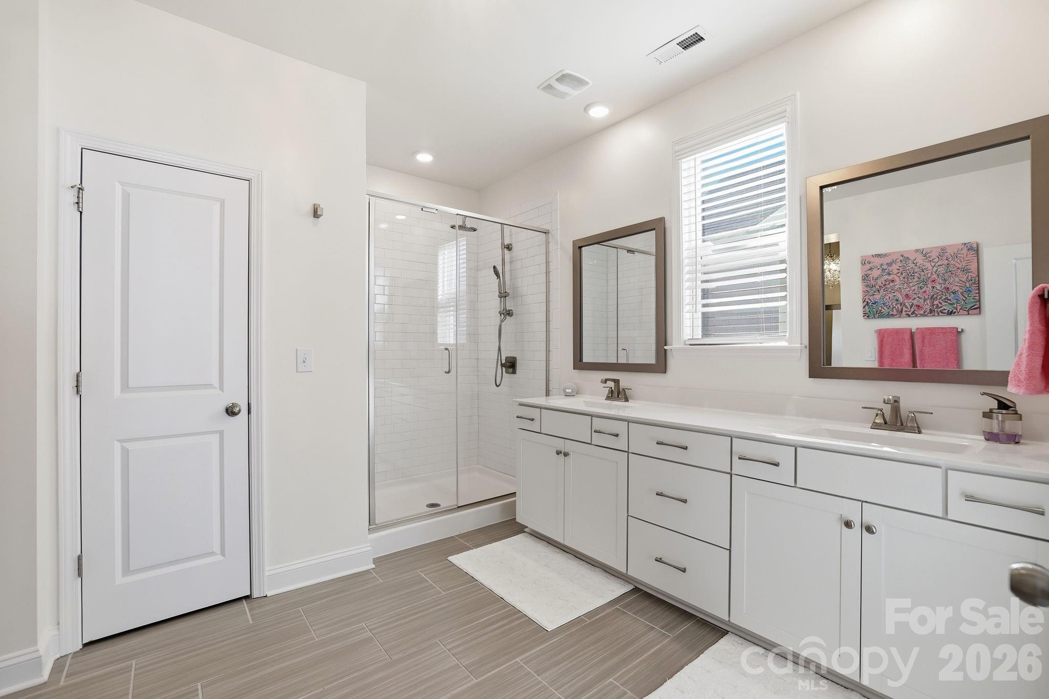 6038 Holland Street Fort Mill, SC 29707 - Photo 21 of 48 a spacious bathroom with double sink and a mirror
