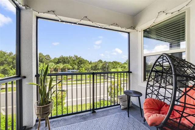 a balcony with chairs and table in wooden floor