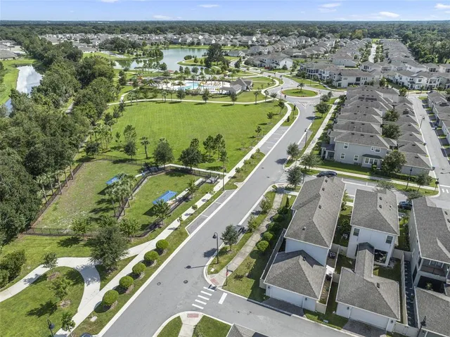 an aerial view of residential houses with outdoor space