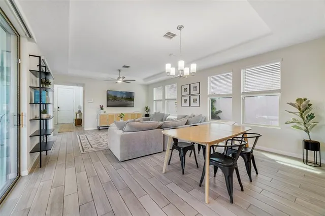 a view of a dining room with furniture and wooden floor