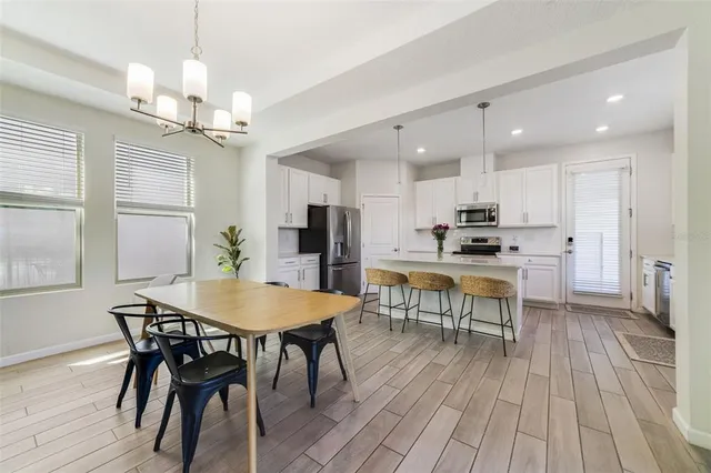 a view of a dining room with furniture and wooden floor