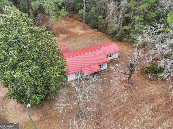 an aerial view of a house with a yard
