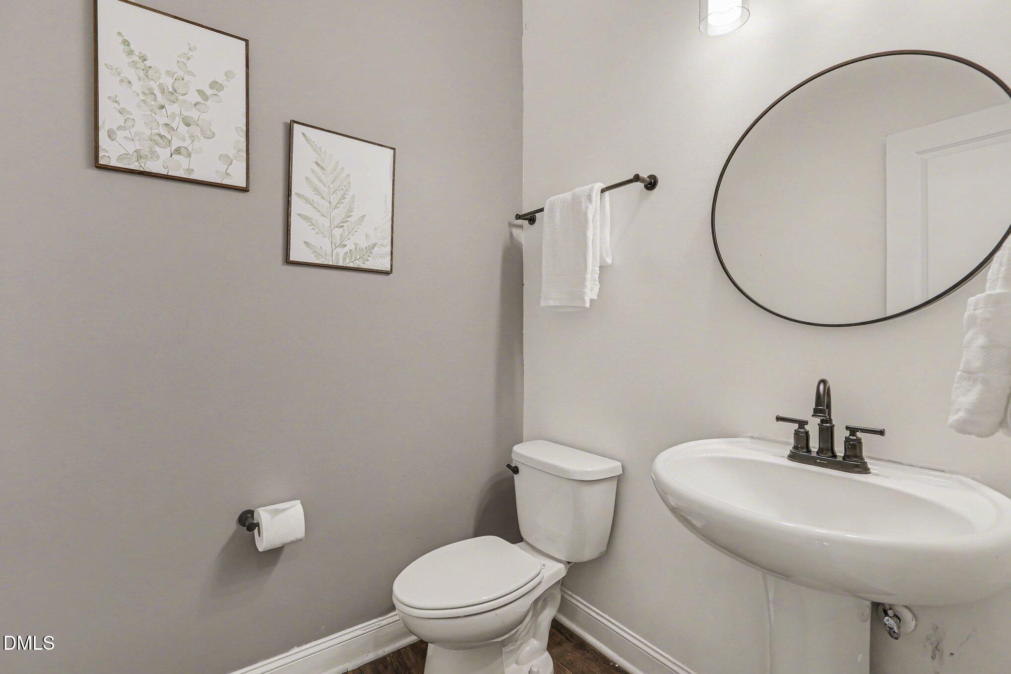 432 Seabring Lane Raleigh, NC 27603 - Photo 23 of 29 a bathroom with a toilet a sink and mirror