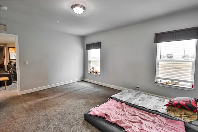 a bedroom with a bed and window