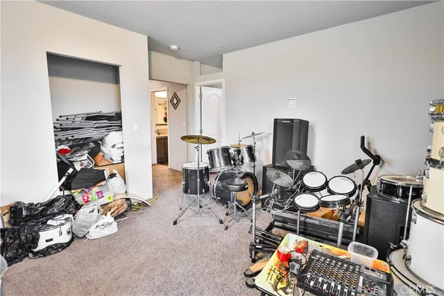 a play room with lots of white furniture and a window