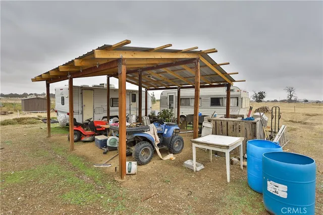 a view of a patio with a table and chairs under an umbrella