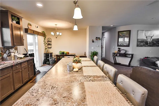 a large bedroom with a large bed and chandelier