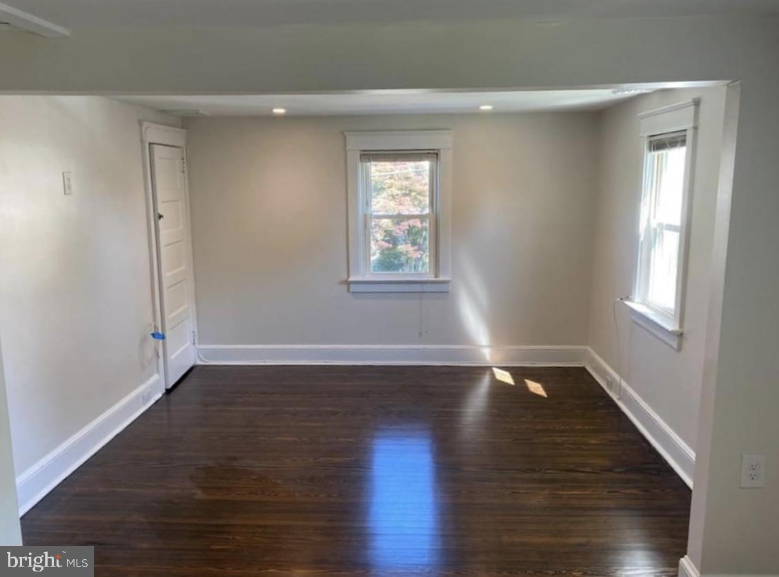 20 Reese Avenue, Unit 2 Newtown Square, PA 19073 - Photo 4 of 7 an empty room with wooden floor and windows