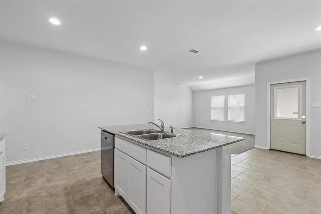 a bathroom with a granite countertop sink and a granite counter tops