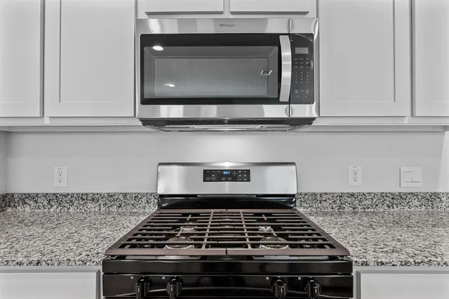 a stove top oven sitting inside of a kitchen