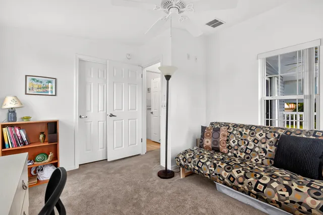 a bedroom with furniture and a book shelf
