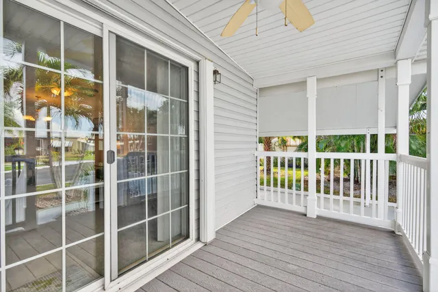 a view of a balcony with floor to ceiling window and wooden floor