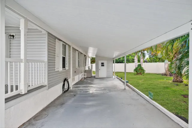 a view of a house with backyard and a porch