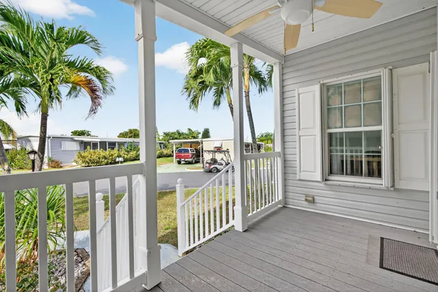 a view of a porch with a table and chairs