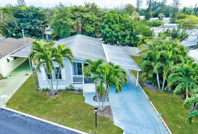 an aerial view of a house with garden space and a patio
