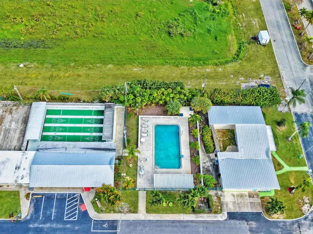 an aerial view of a house with a yard basket ball court and outdoor seating