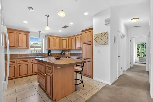 a kitchen with a stove a refrigerator and a sink