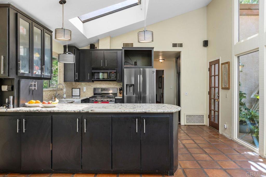 29560 Lilac Road Valley Center, CA 92082 - Photo 12 of 43 a kitchen with stainless steel appliances granite countertop a sink and a refrigerator