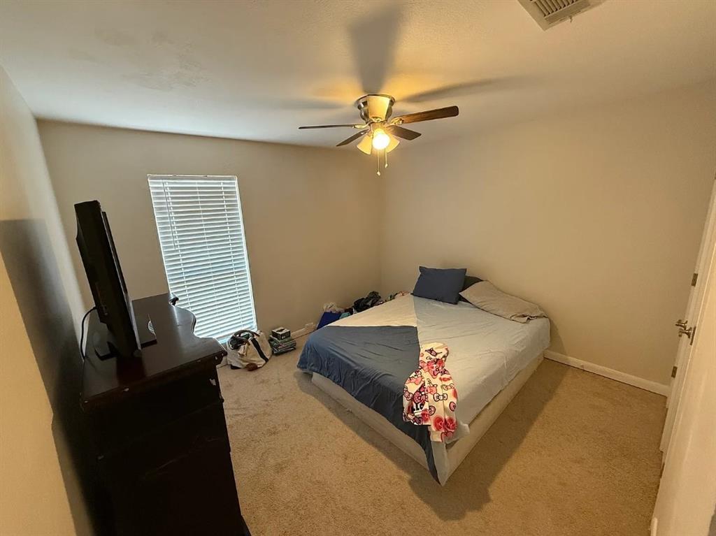 6505 Mc Cormick Ranch Court Plano, TX 75023 - Photo 16 of 21 Carpeted room with a ceiling fan light fixture, light-toned walls, and a window with blinds