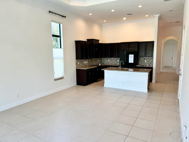 a view of kitchen with stainless steel appliances a refrigerator and a stove top oven with a dishwasher