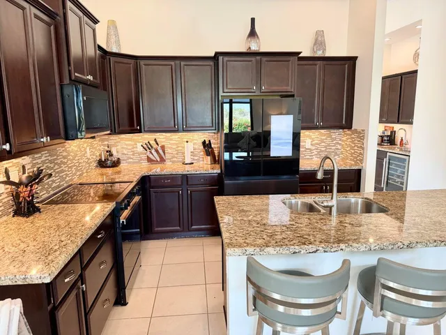 a kitchen with a stove a sink and a refrigerator
