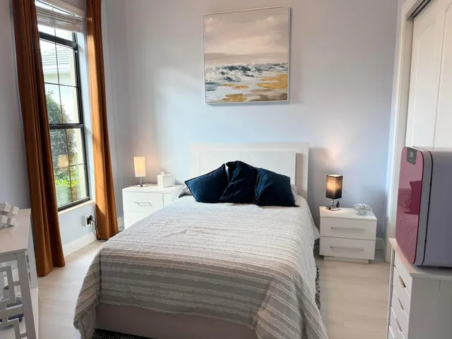 a bedroom with a bed and a window