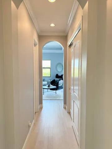 a view of a hallway with a livingroom and furniture