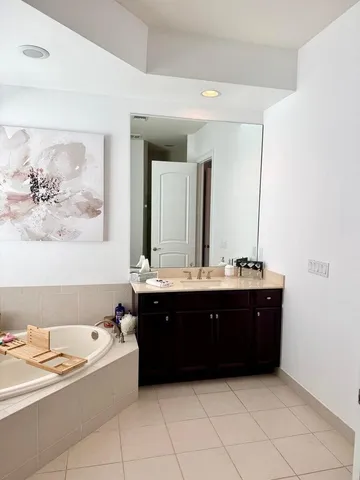 a spacious bathroom with a bathtub and sink