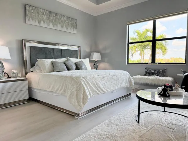 a bedroom with a bed and windows