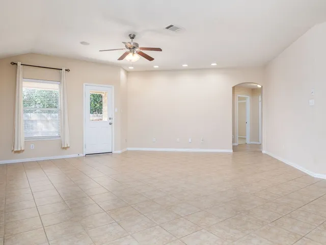 a view of an empty room with a window