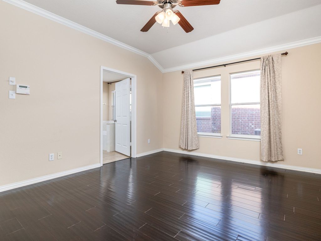 2005 Granite Springs Road Leander, TX 78641 - Photo 15 of 30 a view of an empty room with wooden floor and a window