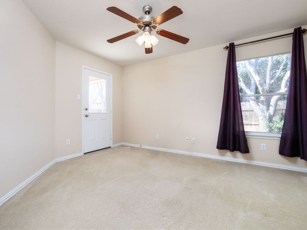 2005 Granite Springs Road Leander, TX 78641 - Photo 17 of 30 an empty room with windows and a ceiling fan