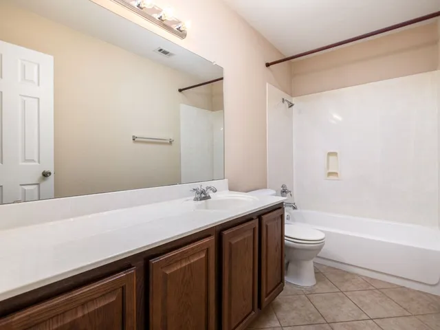 a bathroom with a sink a toilet and bathtub