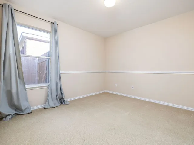 a view of an empty room and a window