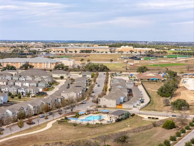 an aerial view of a house with a yard and garden