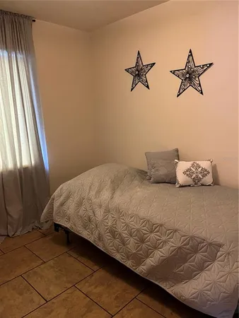 a bedroom with a bed and dresser