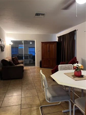 a kitchen with a table and chairs