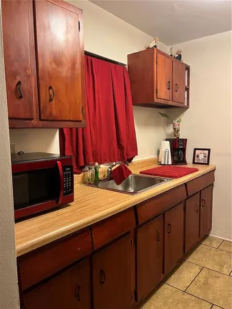 a kitchen with stainless steel appliances wooden cabinets and a sink