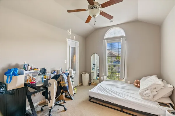 a bedroom with furniture and a window