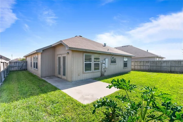 a view of a house with a backyard