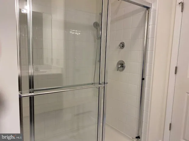 a bathroom with a glass shower door