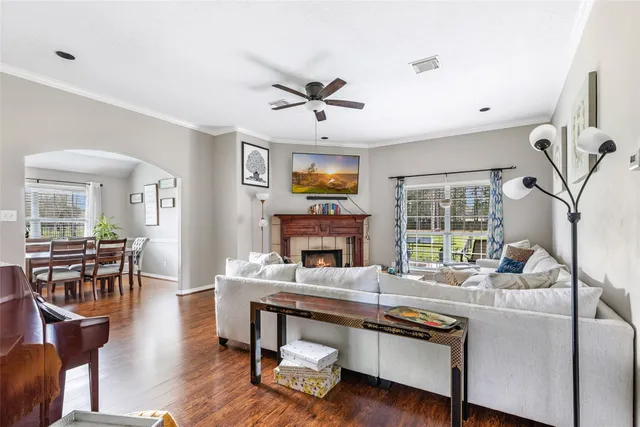 a living room with fireplace furniture and a wooden floor