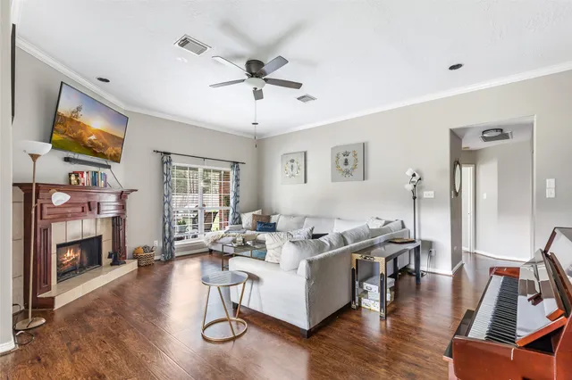 a living room with fireplace furniture and a flat screen tv