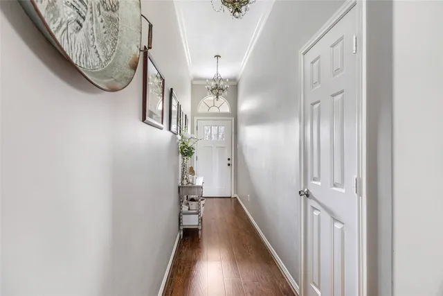 a view of a hallway with wooden floor and entryway