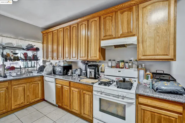 a kitchen with stainless steel appliances granite countertop a sink a stove and cabinets