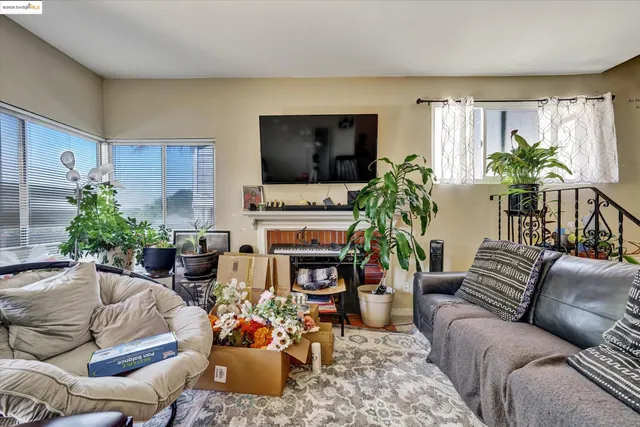 a living room with furniture a flat screen tv and a fireplace